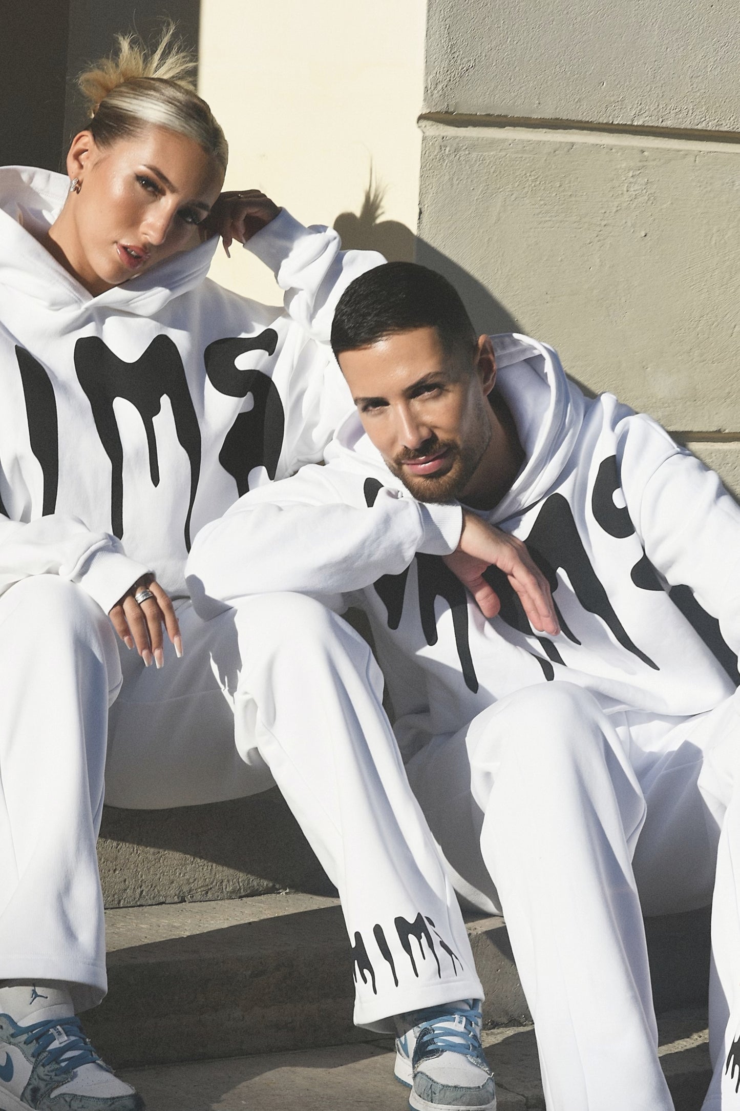 two models posing wearing white clothes