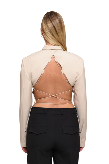 model show back of backless beige blazer