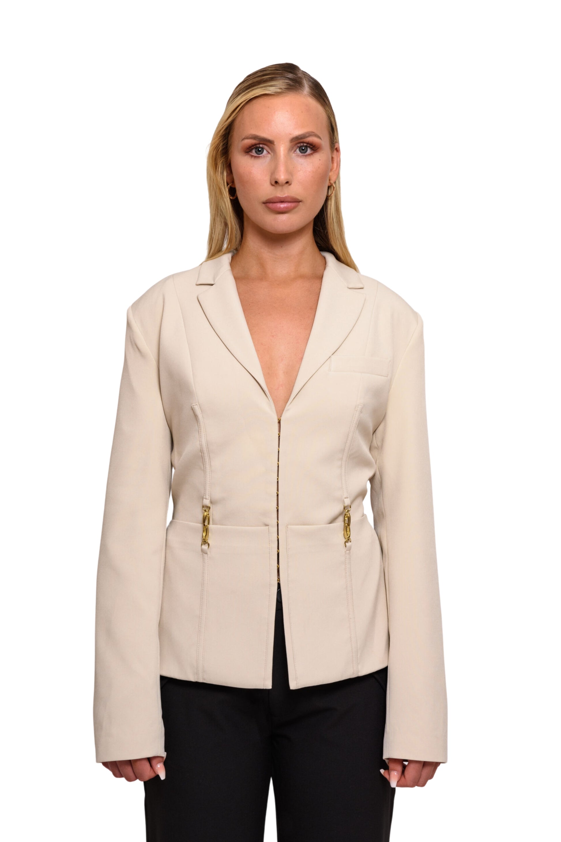 model posing with backless beige blazer